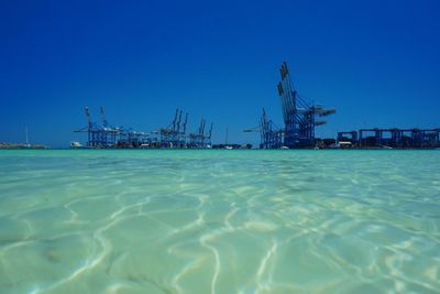 Scenic view of sea against clear blue sky