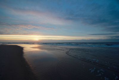 Scenic view of sea against cloudy sky