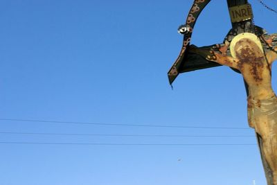 Low angle view of jesus christ statue against blue sky