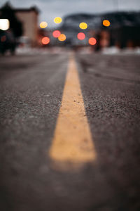 Low angle view of yellow line on paved road.