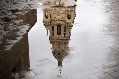 Reflection of tower cathedral in puddle