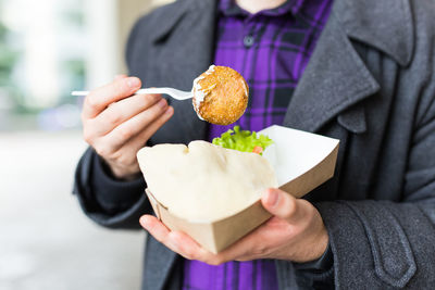 Midsection of woman holding food