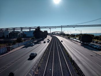 Vehicles on road in city against sky