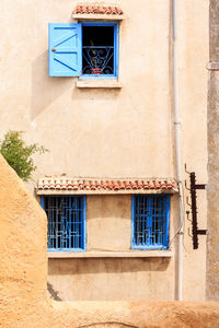 Low angle view of windows on wall of building