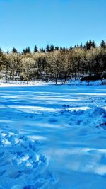 Frozen lake against clear sky