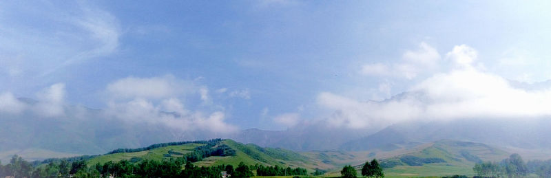 Panoramic shot of countryside landscape against mountain range