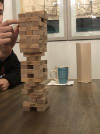 Midsection of man playing with toy on table