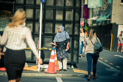 People walking on street in city