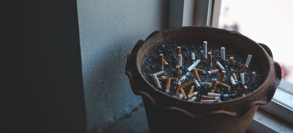 High angle view of cigarette in container on wall