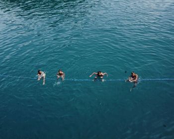 High angle view of people swimming in sea