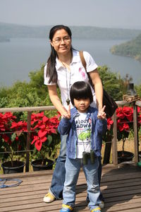 Portrait of mother and son standing at observation point