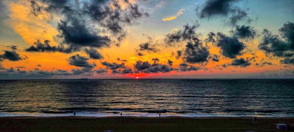 Scenic view of sea against orange sky