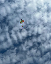 Low angle view of kite flying in sky