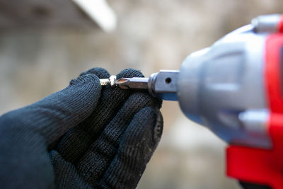 Cropped hand of man holding equipment