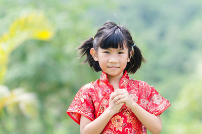 Portrait of girl standing on field