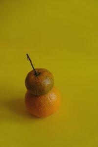 Close-up of apple on yellow background