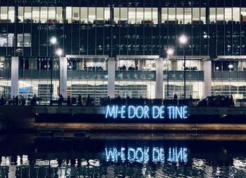 Reflection of illuminated building in river at night