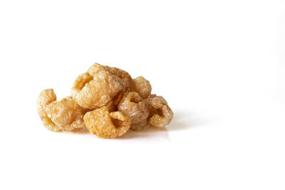 Close-up of bread over white background