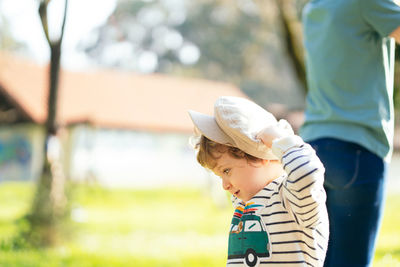 Side view of boy looking at camera