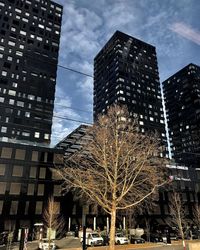 Low angle view of modern buildings in city against sky