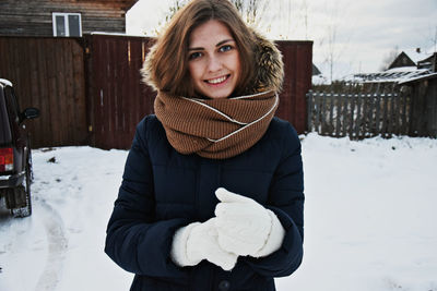 Portrait of smiling woman in snow