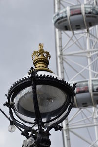 Low angle view of street light and building against sky