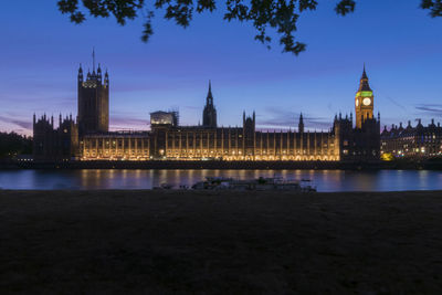 Illuminated buildings in city at waterfront