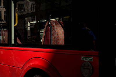 Rear view of man standing in bus