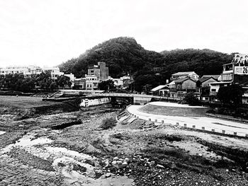 Houses on hill against sky