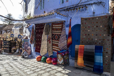 Clothes hanging on street amidst buildings in city