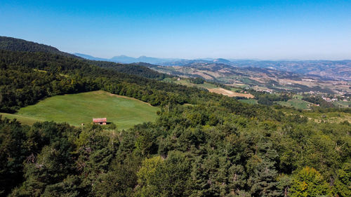 Aerial view from the drone of italian hills with woods and meadows