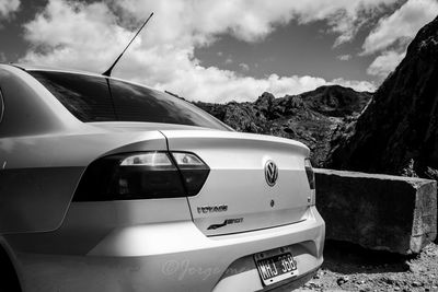 Close-up of vintage car against mountains