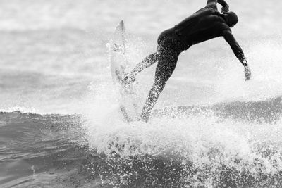 Man surfing on sea against sky