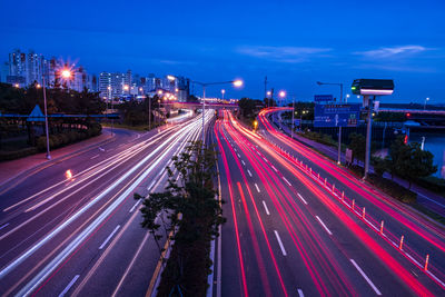 High angle view of light trails on road at night