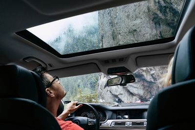 Reflection of man in car window
