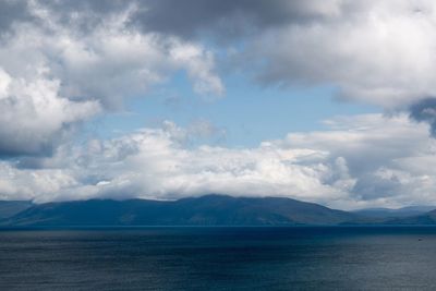 Scenic view of mountains against cloudy sky