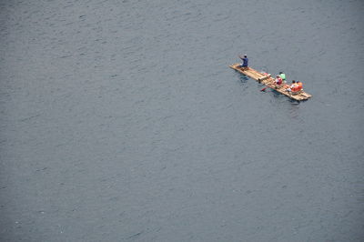 High angle view of people on bamboo raft