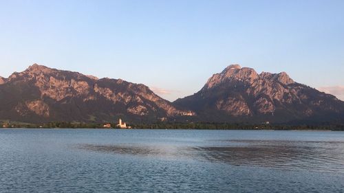 Scenic view of lake and mountains against clear sky