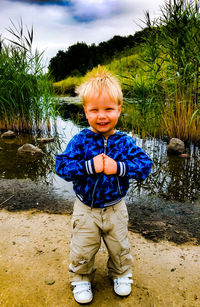 Portrait of cute boy standing on land