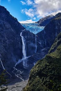 Scenic view of waterfall against sky