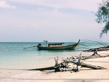 Boat moored in sea against sky