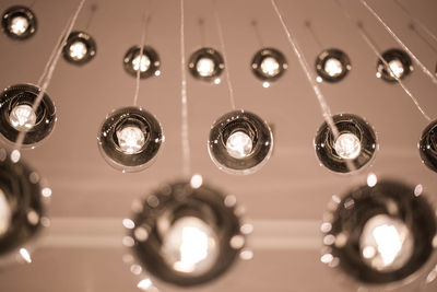 Low angle view of illuminated pendant lights