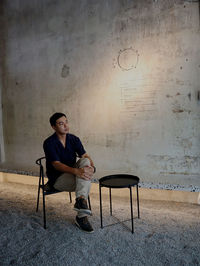 Young man sitting on chair and thinking 