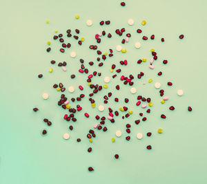 High angle view of multi colored candies against gray background