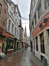 People walking on road along buildings