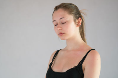 Portrait of a beautiful young woman over white background