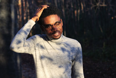 Portrait of young man standing in the woods