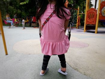 Rear view of woman standing on street