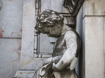 Statue of angel against wall