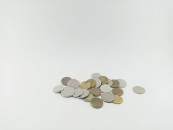 High angle view of coins on white background